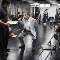 Former Calbee Inc. Chairman and current Rizap Chief Operating Officer Akira Matsumoto participates in a training session for Rizap employees on Aug. 2 in Tokyo. Japan's star businessman who ignores his investors to make them rich