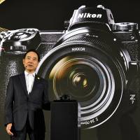 Nikon Corp. President Kazuo Ushida introduces the firm’s first full-frame mirrorless camera series on Thursday in Tokyo. Threatened by emerging technologies, Nikon unveils full-frame mirrorless cameras to keep Sony at bay