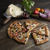 A Veggie Zupreme is one of the items on the menu of Zume Pizza, which speeds up delivery times by employing robots to make the pies enroute. SoftBank mulls major investment in robot pizza startup Zume