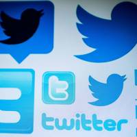 Twitter logos are seen on a computer screen in Beijing. Twitter on Thursday started requiring those behind hot-button issue ads in the U.S. to be vetted as part of the effort by the social network to thwart stealth campaigns aimed at influencing politics. Twitter to verify those behind hot-button U.S. issue ads in bid to squelch stealth campaigns