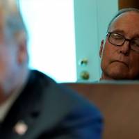 Top White House economic adviser Larry Kudlow sits behind U.S. President Donald Trump during a Cabinet meeting at the White House in Washington Thursday. Where White House boasts a U.S. boom, most economists see a blip