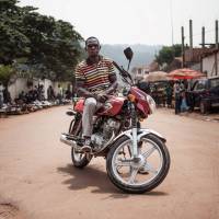 A motorcycle taxi driver, Marcellin, waits for passengers in a street in Bangui on July 21. Russian trio 'carrying press cards' slain in Central African Republic ambush