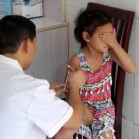 A girl gets a vaccination shot at a hospital in Yunyang County in southwest China’s Chongqing province on Wednesday. China to prosecute suspects at scandal-hit vaccine maker, confiscate illegal income