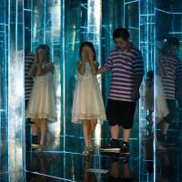 Children visit a maze constructed with mirrors at a mall in Beijing on Thursday. No children? Pay a tax, Chinese academics suggest