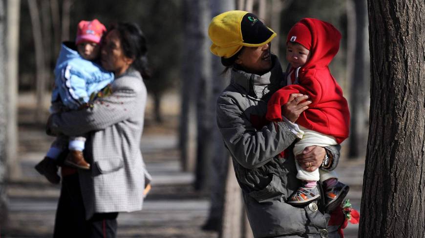 Families visit a park in Beijing in 2013. China appears poised to scrap its two-child policy, with a state-run newspaper citing a draft civil code that would overhaul decades of controversial family-planning rules. Given the right to larger families, Chinese may hold off