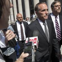 Republican U.S. Rep. Christopher Collins (center) is surrounded by reporters as he leaves federal court, Wednesday in New York. Rep. Collins of western New York state has been indicted on charges that he used inside information about a biotechnology company to make illicit stock trades. GOP Rep. Chris Collins, an early Trump loyalist, charged with insider trading