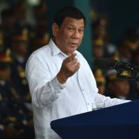 Philippine President Rodrigo Duterte speaks at the 117th police anniversary celebration at the national headquarters in Manila on Aug. 8. Duterte calls 'wrong' China's claim to airspace and waters around islands in South China Sea