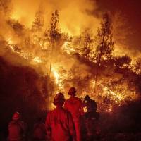 Firefighters monitor a backfire while battling the Ranch Fire, part of the Mendocino Complex Fire near Ladoga, California, Aug. 7. The years with the most acres burned by wildfires have some of the hottest temperatures, an Associated Press analysis of fire and weather data found. As human-caused climate change has warmed the world over the past 35 years, the land consumed in flames has more than doubled. Science of U.S. West: 'The warmer it is, the more fire we see'