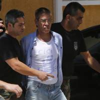 EgyptAir plane hijacking suspect Seif Eddin Mustafa, with a t-shirt reading “Cici Killer,” is escorted by Cyprus police officers as he arrives in a court in Nicosia in 2016. Cyprus extradites Egyptian hijacker after he drops legal fight