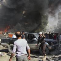 Civil Defense workers and Syrian citizens gather after an airstrike hit a market in the Maaret al-Numan area of southern Idlib, Syria, last October. Last stand: The looming, final battle for Syria's rebels