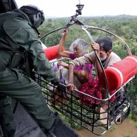 People are airlifted by the Indian Navy during a rescue operation at a flooded area in the southern state of Kerala on Friday. Death toll jumps to 164 in flooding in India's Kerala state