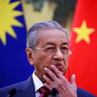 Malaysia’s Prime Minister Mahathir Mohamad speaks during a news conference at the Great Hall of the People in Beijing on Tuesday. Malaysian leader says China-financed projects are canceled