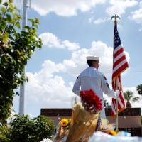 Kyle Vonnahme of the Naval Sea Cadet Corps stands outside of A.L. Moore-Grimshaw Mortuary in north Phoenix, Arizona, guarding the body of the late U.S. Sen. John McCain on Sunday. McCain funeral speakers expected to include Bush and Obama; tributes continue to pour in