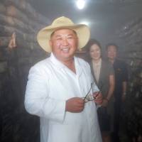 North Korean leader Kim Jong Un smiles as he provides field guidance at a catfish plant in this undated photo released Sunday. North Korea says it is demonstrating good faith and urges U.S. to drop sanctions