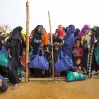 Rohingya Muslim women with their children stand in a line outside a food distribution center at Bthe alukhali refugee camp 50 km (32 miles) from, Cox’s Bazar, Bangladesh, in January. Myanmar not addressing concerns of over 1 million displaced Rohingya, Bangladesh tells UNSC