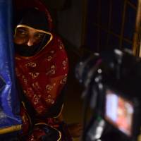 A Rohingya refugee speaks on-camera to a volunteer on July 21 at Balukhali camp, in Ukhia, to give an account of alleged abuses by Myanmar soldiers before she fled to Bangladesh. Catalog of abuse: Quietly seeking justice for the Rohingya