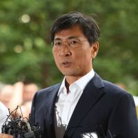 Ahn Hee-jung (right), former South Korean presidential contender of the ruling Democratic Party, arrives at a court for his sex abuse trial in Seoul on Tuesday. Ahn was cleared of all charges in a case stemming from allegations he raped a female aide on several occasions. Former South Korea presidential hopeful acquitted in sex abuse case