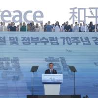 South Korean President Moon Jae-in delivers a speech below characters and letters reading “Peace” during a ceremony marking the 73rd anniversary of the end of Japanese colonial rule in 1945, at the National Museum of Korea in Seoul on Aug. 15. East Asian 'railroad community' offers path to North Korea peace, says South Korean President Moon Jae-in