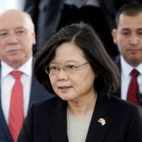 Taiwan’s President Tsai Ing-wen walks alongside Paraguay’s Foreign Minister Eladio Loizaga in Luque, Paraguay, on Aug. Taiwan calls China 'out of control' as it looses El Salvador to Beijing
