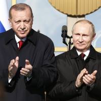 Turkey’s President Recep Tayyip Erdogan (left) and Russia’s President Vladimir Putin applaud during a welcome ceremony prior to their meeting at the Presidential Palace in Ankara, Turkey on April 3, 2018. In familiar dance, Turkey warms to Russia as US ties worsen