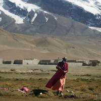 A Uighur woman dries clothes on the ground south of Kashgar. U.N. says it has credible reports China is holding 1 million Uighurs in secret camps