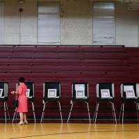 A voter uses an electronic voting machine to cast a ballot during the Georgia primary runoff elections in Atlanta, Georgia, U.S., on July 24. Georgia is among 14 states using touchscreen, computerized machines that don’t meet federal security guidelines because they produce no paper record, preventing voters from verifying their choices and officials from auditing the results. Boy, 11, hacks into replica U.S. election website in minutes as convention probes electronic voting systems