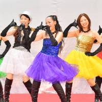 Members of Dream 39 — (from left) Shige, Hazuki, Riko, Nao and Akane — perform at San-A Hamby Town in Chatan, Okinawa Prefecture, on June 17. 'Namie Amuro generation': Okinawa moms pursue dream of fame