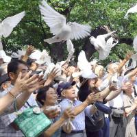 Attendees release doves at Yasukuni Shrine in Tokyo on Wednesday to commemorate the 73rd anniversary of the end of World War II. Japanese remember the fallen and pray for a peaceful future on WWII anniversary