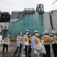 Foreign journalists receive information about decommissioning work at the crippled Fukushima No. 1 nuclear power plant in Okuma, Fukushima Prefecture, on July 27. Extreme makeover: Tepco attempts image overhaul at Fukushima nuclear plant