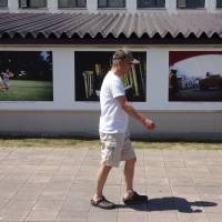 A visitor to a summer photography festival walks by a wall of photos on display in downtown Higashikawa, Hokkaido, in early August. How one Hokkaido town curbed population decline in graying Japan