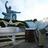 A woman prays for atomic bomb victims on the 73rd anniversary of the Nagasaki bombing at the Peace Memorial Park in Nagasaki on Thursday. Nagasaki mayor presses Japan to lead efforts toward nuclear-free world as city marks 73rd anniversary of A-bomb