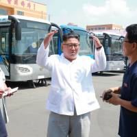 North Korean leader Kim Jong Un visits an unidentified site in the country for a trial operation of a new type of trolley bus in this photo released on Aug. 4. North Korea detains Japanese man, casting cloud over abduction negotiations