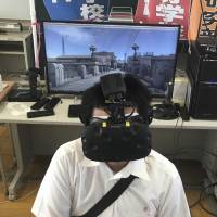 Namio Matsura, a 17-year-old who belongs to the computer club at Fukuyama Technical High School in Hiroshima Prefecture, experiences through virtual reality the city of Hiroshima before the atomic bomb fell. Students use VR to re-create Hiroshima bombing