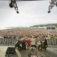 Gig with a view: Tom Misch (center) and his band pose for an end-of-concert shot at the Beach Stage at Summer Sonic in Tokyo. Sunset and a glimpse of Mount Fuji add to Tom Misch's Tokyo debut