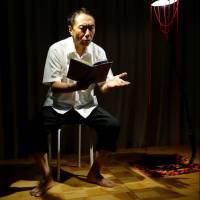 Keeping the story alive: Tatsushi Amano, next to his homemade lamp, performs “Living With Father.” Keeping the lesson of Hiroshima alive through one family's story