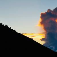 High and dry: Climbers watch the sunrise on Mount Fuji. Mount Fuji: Cycling sea to summit for sunrise