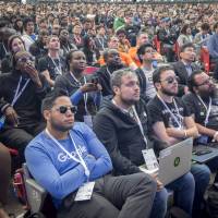 Attendees watch a presentation at a Google conference in Mountain View, California, on May 8. Pressure from thousands of Google workers led CEO Sundar Pichai to end the firm’s participation in a program to create a customized AI surveillance engine for military drones. An outbreak of ethics in Silicon Valley?