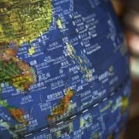 A globe on display at a bookstore in Beijing on July 13 shows islands in the South China Sea within the “nine-dash line” that represents China’s territorial claims. On July 12, 2016, an arbitral tribunal ruled that the nine-dash line is in violation of the United Nations Convention on the Law of the Sea, but China has ignored the ruling. Beijing's South China Sea project must not succeed