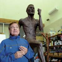 Olympic legend Billy Mills stands next to a giant statue depicting him at the 1964 Tokyo Summer Games created by Native American artist George Rivera. Statue honoring 1964 Olympic icon Billy Mills needs home
