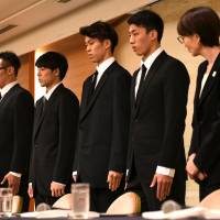 National basketball team players (from left) Yuya Nagayoshi, Takuya Hashimoto, Takuma Sato and Keita Imamura, and Japan Basketball Association chairperson Yuko Mitsuya attend a news conference in Tokyo on Monday. Disgraced basketball players face the music after sex scandal