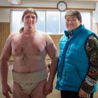 Canadian Brodie Henderson (left), also known as Homarenikishi, stands with stablemaster Nishikido after being accepted into his stable on Feb. 7, 2015. Entering sumo world not something to be taken lightly