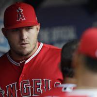 Angels superstar Mike Trout stands in the dugout on Saturday in Cleveland. Angels' Mike Trout gets cortisone injection in wrist, misses fifth consecutive game