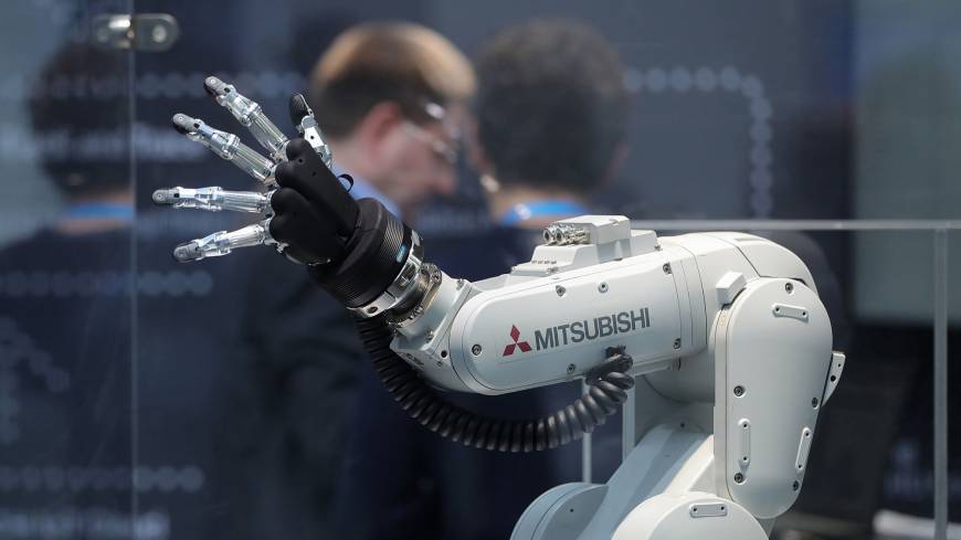 A Mitsubishi Melfa robotic arm, manufactured by Mitsubishi Electric Corp., is displayed at the Robert Bosch GmbH Internet of Things conference in Berlin in February. Despite government push of AI and robots, Japanese fear tech to lead to inequality and job losses: survey