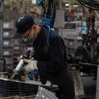 An employee works on an SUV production line of the automaker BAIC in Beijing on Aug. 29. China is the world’s No. 1 trader, but its exports have shrunk as a share of the economy. Trump tariff fight adds to China's economic challenges as retail, other sectors sag