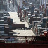 A truck transports a container at the Yangshan Deep Water Port in Shanghai. China's trade outlook darkens as Trump raises stakes on tariffs
