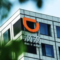 A Didi Chuxing sign hangs on a building in Hangzhou in China’s eastern Zhejiang province. Chinese taxi-hailing Didi app to debut in Osaka, possibly in September