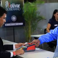 Venezuelan President Nicolas Maduro participates in the process of buying a savings certificate in gold at Venezuela’s Central Bank in Caracas, Venezuela in this handout picture obtained by Reuters Monday. Maduro buys gold to boost savings amid Venezuela's five-digit inflation but few other takers seen