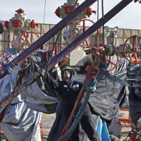 A worker adjusts pipes during a hydraulic fracturing operation at a well pad near Mead, Colorado, in 2014. The Trump administration is moving to roll back Obama-era rules intended to reduce leaks of climate-changing methane from oil and gas facilities. The Environmental Protection Agency formally released a proposed substitute rule Tuesday. The EPA acknowledges the rollback would lead to more methane leaking into the atmosphere. The agency says relaxing oversight will save $75 million in regulatory costs annually. EPA closer to rolling back Obama-era rules on methane, admits added pollution will hurt air, health