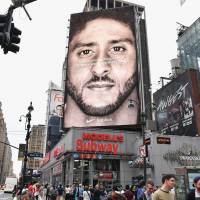 A Nike ad with quarterback Colin Kaepernick is displayed in New York on Sept. 8. Nike shares hit record high after ads with racism protester Colin Kaepernick are unveiled