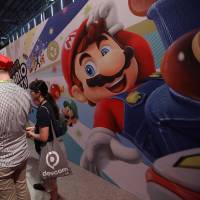 Gamers play the ‘Super Mario Party’ computer game on a Nintendo Switch console at the Nintendo Co. stand at the Gamescom gaming industry event in Cologne, Germany, in August. Nintendo is finally launching its first online subscription service. Nintendo debuts subscription service for its widely derided online offering